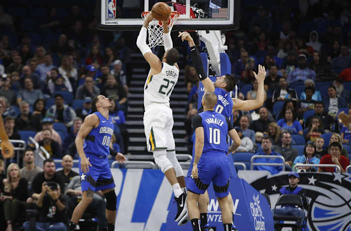 Rudy Gobert (27) dunks over Nikola Vucevic (9) and Aaron Gordon (00)